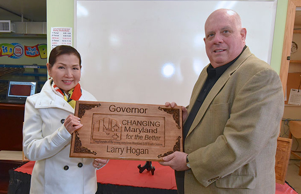 Governor Larry Hogan and First Lady Yumi Hogan Holding Changing Maryland for the Better Plaque